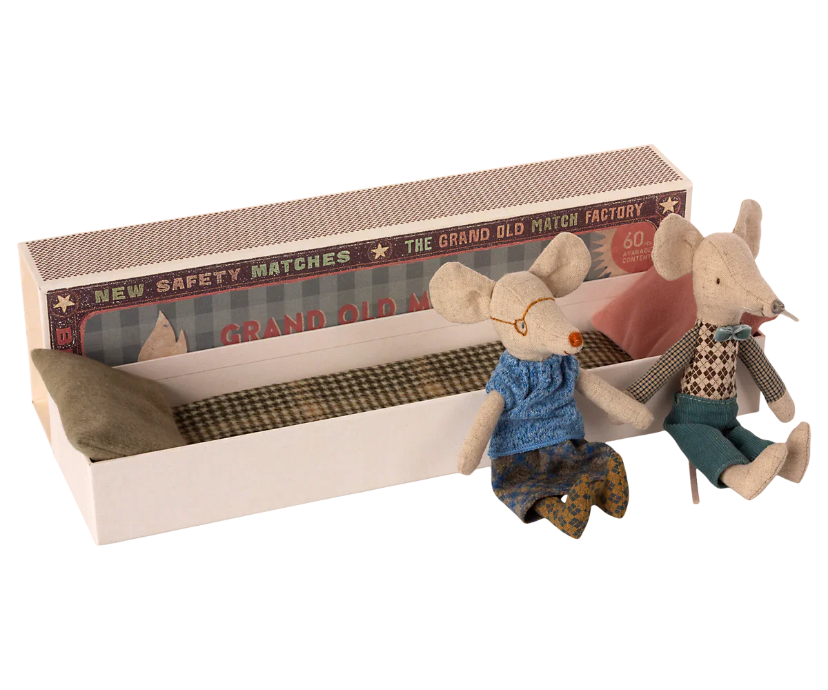 The Maileg Mail Grandma & Grandpa Mice in Matchbox features two charming fabric dolls, styled as Grandma and Grandpa mice, snuggled inside a matchbox bed complete with pillows and a blanket—an adorable kids' toy.