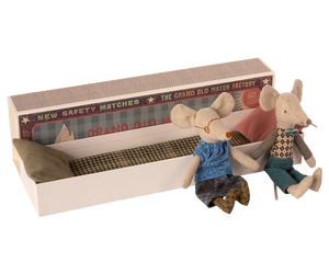 The Maileg Mail Grandma & Grandpa Mice in Matchbox features two charming fabric dolls, styled as Grandma and Grandpa mice, snuggled inside a matchbox bed complete with pillows and a blanket—an adorable kids' toy.