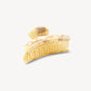 The Grande Heirloom Claw by Machete, shown against a plain white background, is a large marble-patterned hair claw clip in beige and brown, expertly crafted from premium Italian acetate with curved prongs. Designed for long, thick hair, it combines secure hold with timeless style.