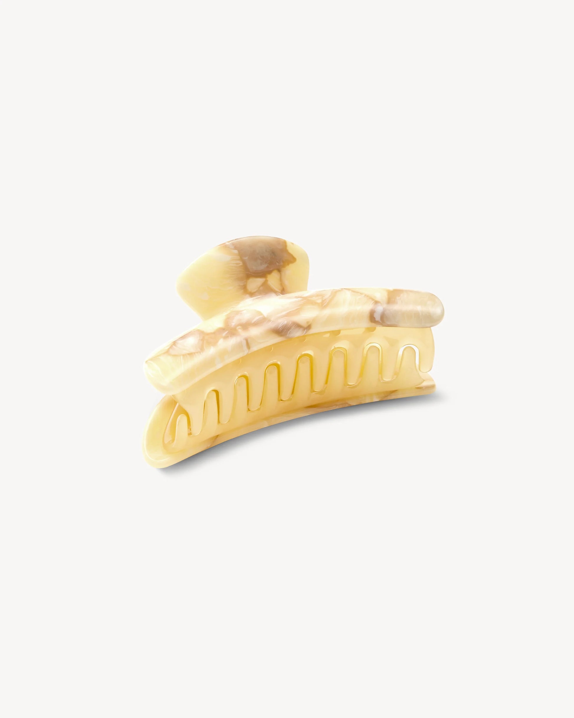 The Grande Heirloom Claw by Machete, shown against a plain white background, is a large marble-patterned hair claw clip in beige and brown, expertly crafted from premium Italian acetate with curved prongs. Designed for long, thick hair, it combines secure hold with timeless style.