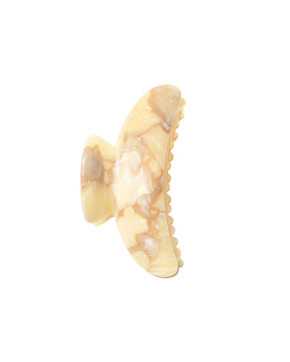 The Machete Grande Heirloom Claw, shown against a white background, is a beige and light brown marbled hair clip made from premium Italian acetate, featuring curved edges and interlocking teeth for a secure hold on long, thick, or voluminous hair.