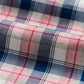 Close-up of the Johnnie-O Granger Button Down by Johnnie-O, showcasing ultra-premium plaid fabric with red, blue, and white stripes in luxe cotton gently folded.