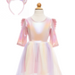 The Great Pretenders Alicorn Dress with Wings and Headband features pastel colors, a rainbow tulle skirt, iridescent bodice, magical wings, and a unicorn horn headband decorated with flowers and ears.