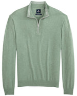 The Johnnie-O Desmond Quarter Zip is a green sweater with white zipper piping, made from a cotton-rich blend, featuring ribbed cuffs and hem. This pullover combines comfort and style for year-round wear.