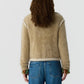 Person with long curly hair, wearing the Guest in Residence Grizzly Frankie Jacket and blue jeans, shown from the back against a plain light background.