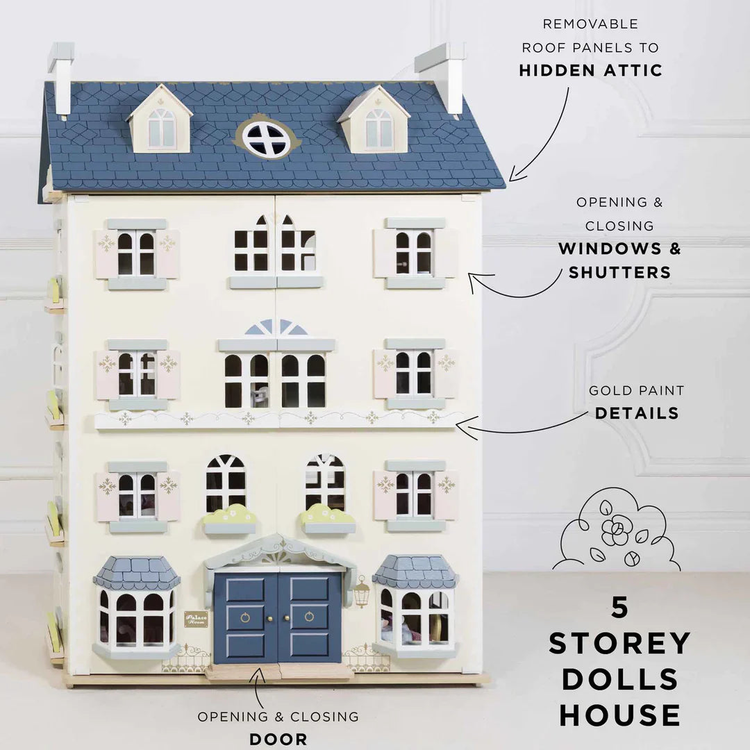 An imaginative play dollhouse with blue windows and blue shutters by Le Toy Van.