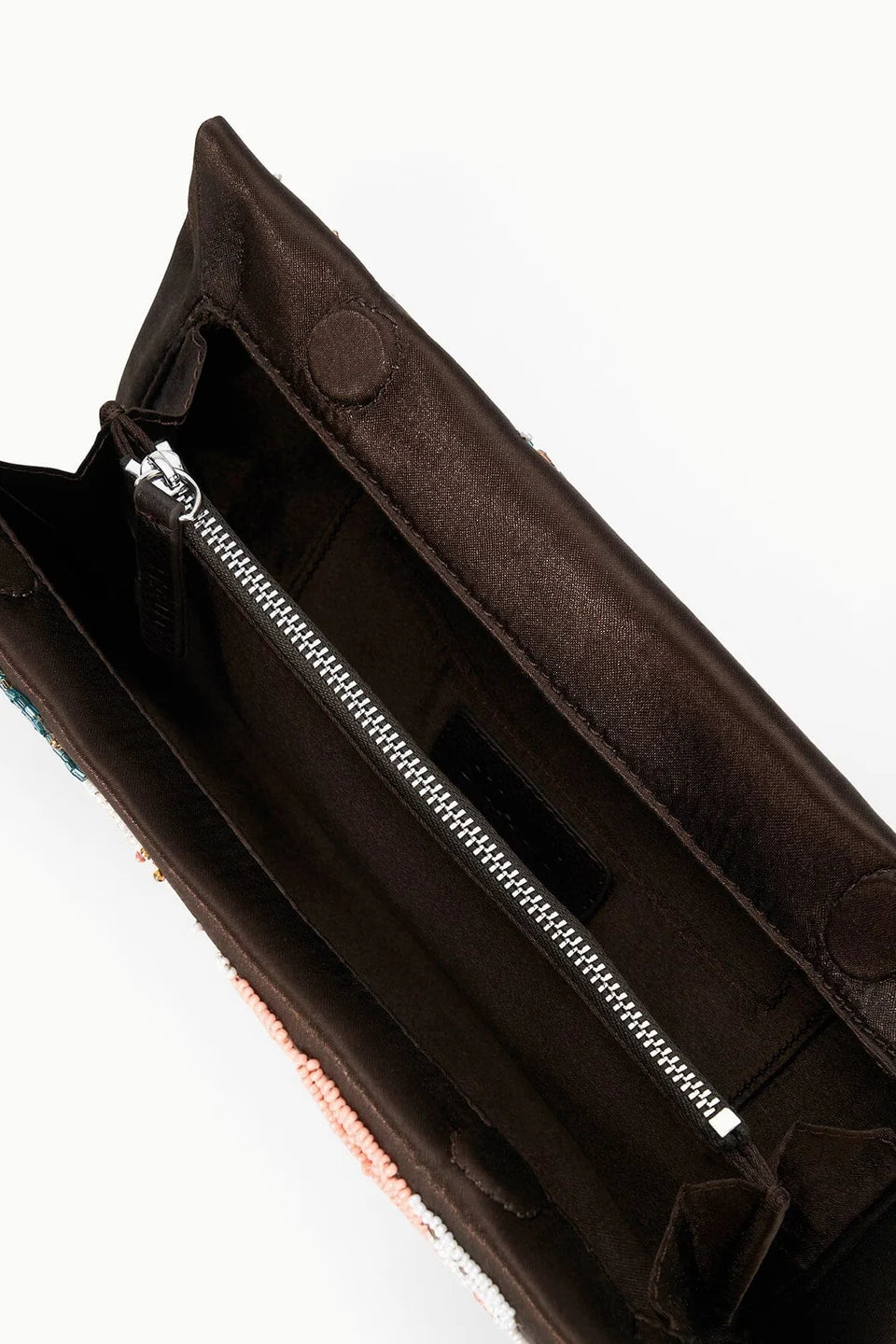 Open brown Staud Muse Clutch shown from above, revealing a zippered interior pocket and snap closures on the flap—an ideal evening accessory to complement your favorite occasion dresses.