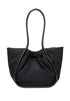 The Proenza Schouler Large Ruched Puffy Nylon Tote in black showcases a distinctive looped handle design and a gathered top, enhanced by a gold-tone logo for an elegant touch.