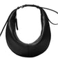 The Proenza Schouler Slide Bag is a black crescent-shaped leather shoulder bag with a long adjustable strap and secure zipper closure from Proenza Schouler.