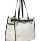 The Proenza Schouler Belted Canvas Tote is a rectangular, white bag featuring black leather straps and trim. This structured tote also includes a small embroidered monogram "S" on the lower right corner.