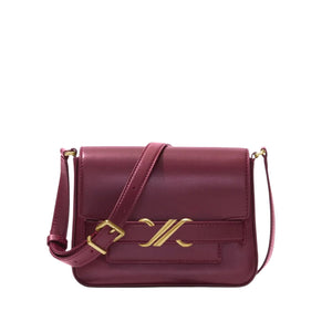 The Proenza Schouler Monogram Box Bag, a maroon leather shoulder bag featuring gold hardware and flap closure. It includes an adjustable strap for crossbody use and is decorated with a gold emblem on the front.