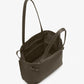 The Days Pebbled Calf Skin Tote by Proenza Schouler is a dark gray calfskin bag with two handles, an open top, inner pockets, and a suede-like interior, shown against a white background.