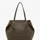 The Proenza Schouler Days Pebbled Calf Skin Tote is a large, brown bag featuring two long handles and side buckle details, shown against a plain white background.