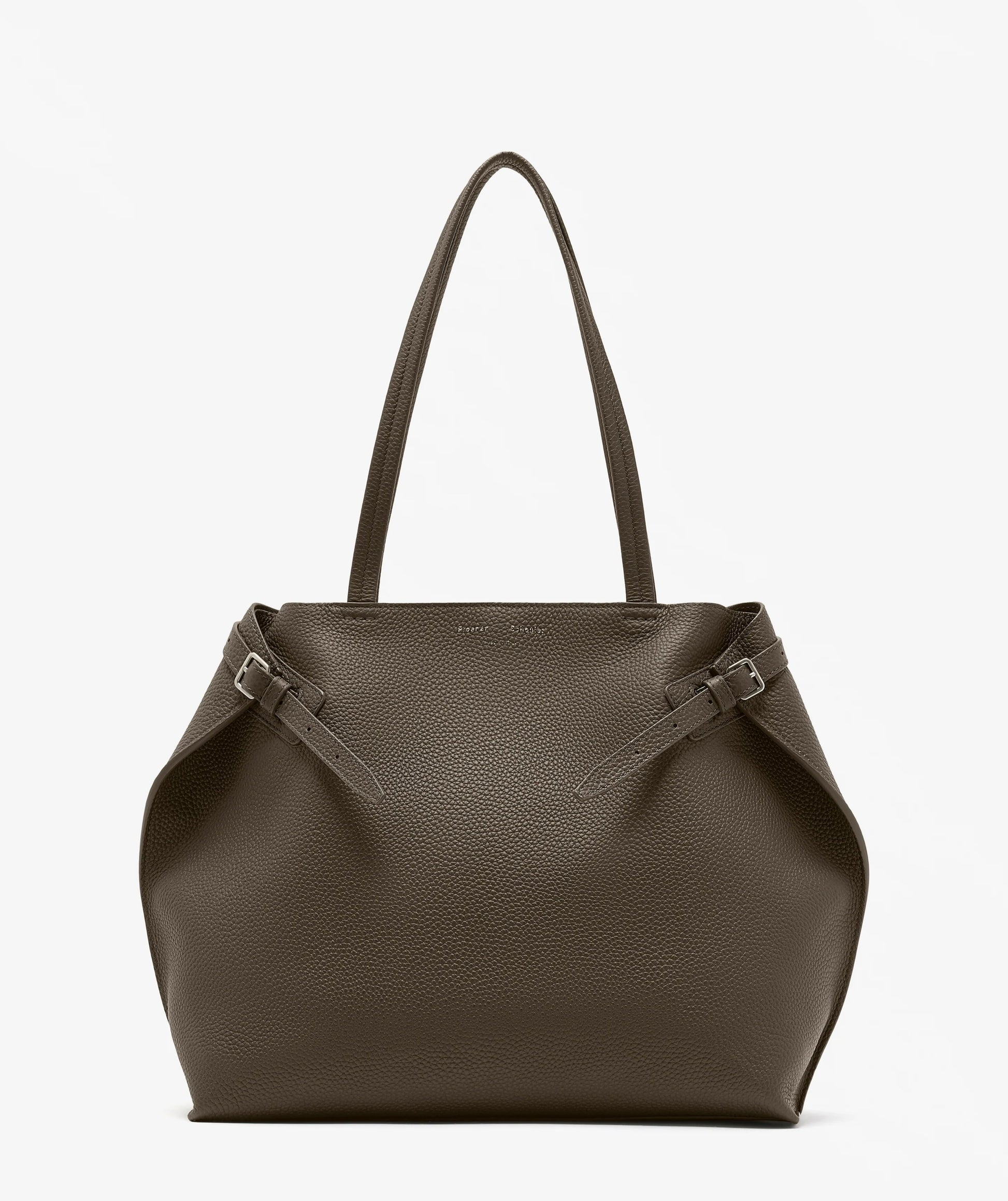 The Proenza Schouler Days Pebbled Calf Skin Tote is a large, brown bag featuring two long handles and side buckle details, shown against a plain white background.