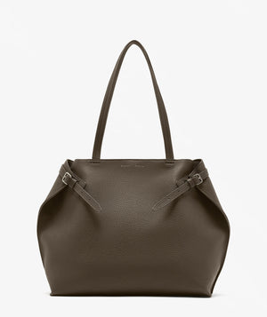 The Proenza Schouler Days Pebbled Calf Skin Tote is a large, brown bag featuring two long handles and side buckle details, shown against a plain white background.