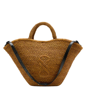 The Large Chelsea Natural Raffia Tote by Proenza Schouler features a curved brown woven design, short top handles, a black adjustable leather shoulder strap, and an embossed "S" on the front.