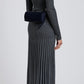 A person in a long, ribbed gray dress and black boots is shown from the back, carrying a Proenza Schouler Silo Crossbody Bag with an adjustable strap over their shoulder.