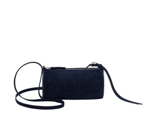 The Proenza Schouler Silo Crossbody Bag is a small, rectangular, dark blue suede bag with an adjustable strap and top zipper closure, shown against a white background.