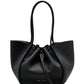 The Proenza Schouler Large Ruched Soft Pebbled Calf Tote is a black pebbled leather bag with two handles, a drawstring closure, and a detachable leather zip pouch.