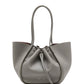 The Proenza Schouler Large Ruched Soft Pebbled Calf Tote in grey features a drawstring closure, two long handles, and comes with a matching leather zip pouch, all set against a plain white background.