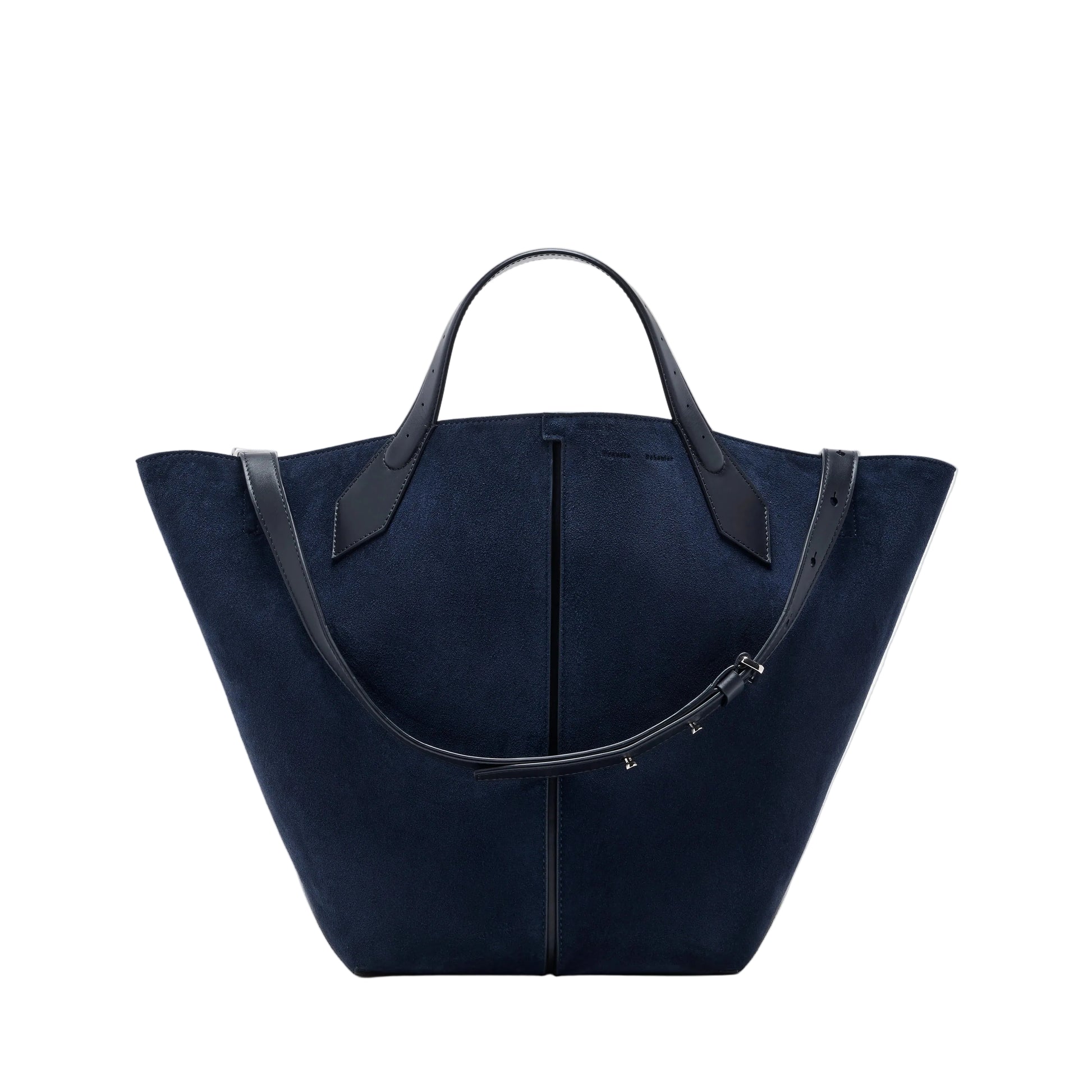The Chelsea Large Soft Suede Tote by Proenza Schouler, shown in navy blue with two black leather handles and an adjustable shoulder strap, features an unstructured silhouette and is photographed on a white background.