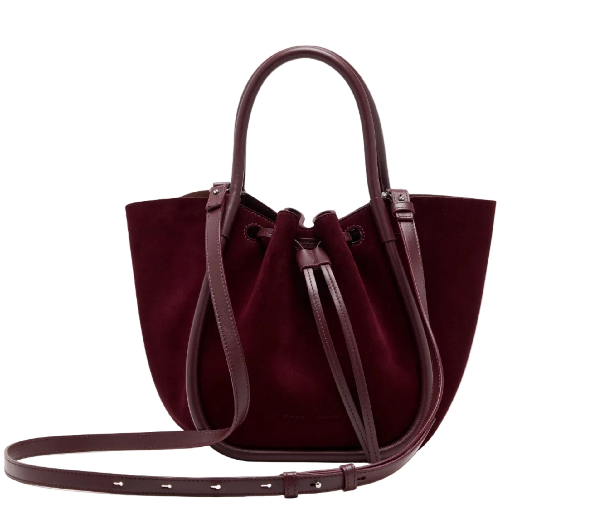 The Proenza Schouler Small Ruched Soft Suede Tote features soft burgundy suede, leather handles, a sculptural shape, long adjustable shoulder strap, and drawstring closure.