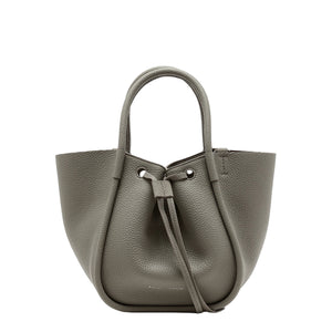 The Proenza Schouler Small Ruched Soft Pebbled Calf Tote in gray leather features a sculptural silhouette, drawstring closure, and double handles, displayed against a plain white background.