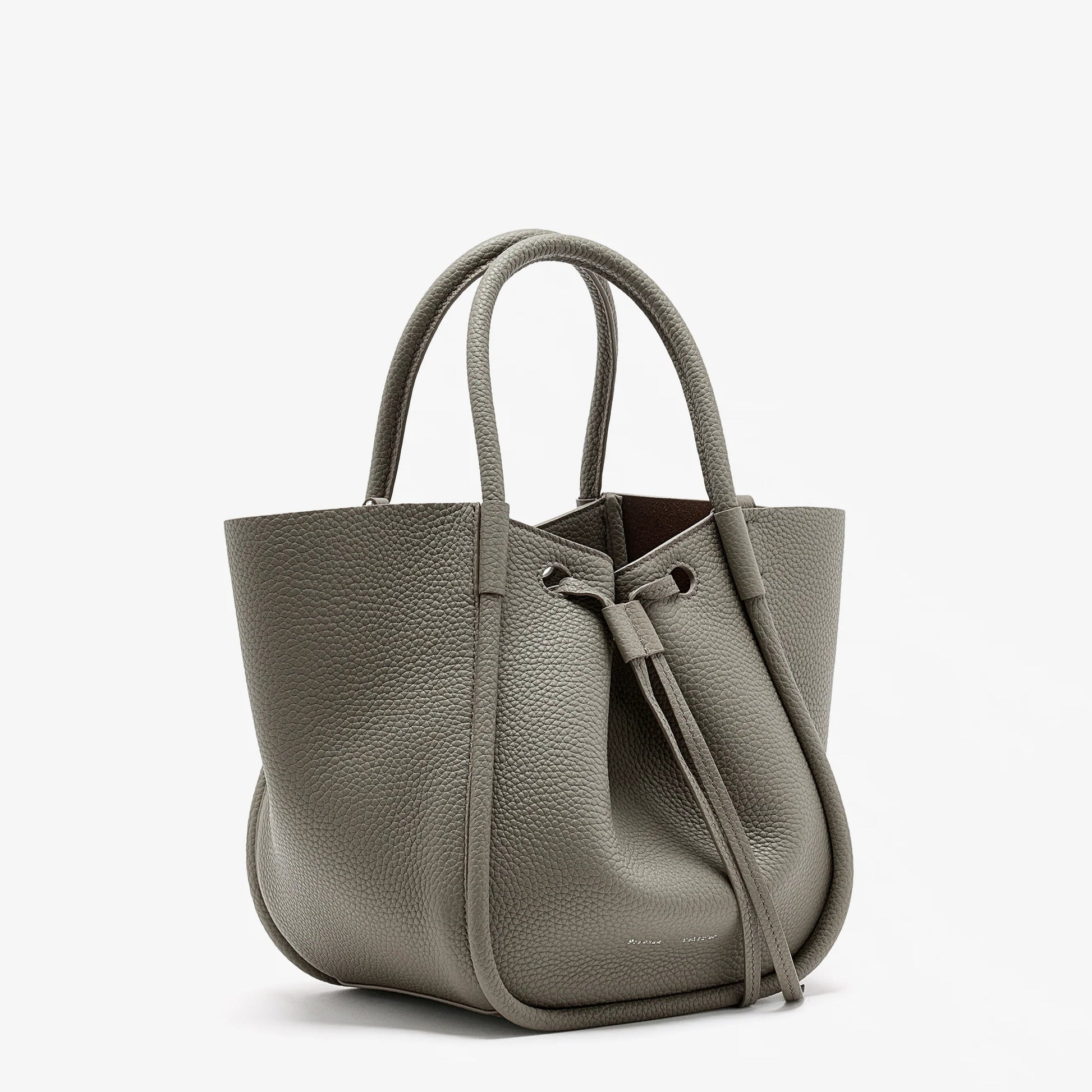 The Proenza Schouler Small Ruched Soft Pebbled Calf Tote is a textured gray leather bag with two handles and a ruched drawstring open top, shown against a white background.