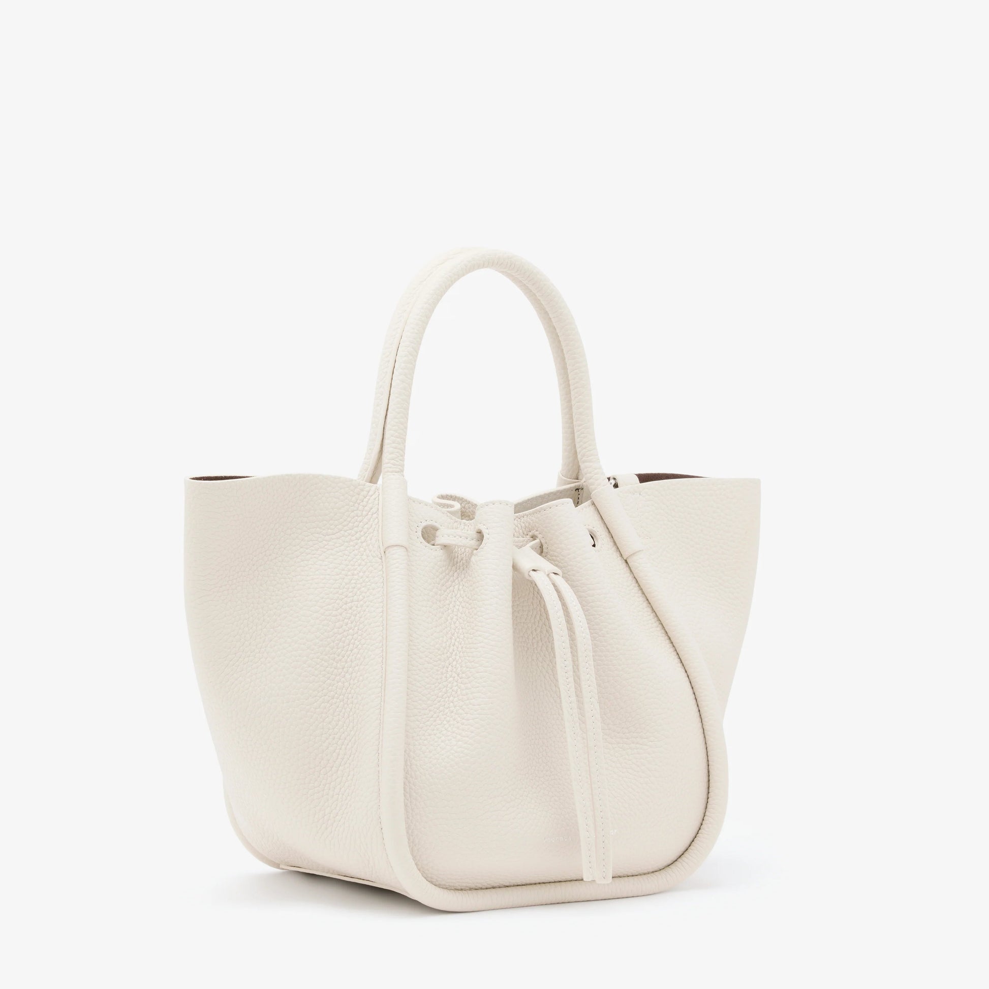 The Proenza Schouler Small Ruched Soft Pebbled Calf Tote in white leather features a sculptural silhouette, two handles, and a ruched open top with drawstring closure, shown against a plain white background.