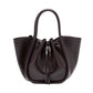 The Proenza Schouler Small Ruched Soft Shiny Tote, crafted in dark brown leather, features two handles and a ruched open top with drawstring closure, showcasing a sculptural silhouette, and is displayed on a plain white background.