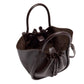 The Small Ruched Soft Shiny Tote by Proenza Schouler is a dark brown leather bucket bag with a sculptural silhouette and two handles. It features an open top with ruched detailing, a drawstring closure, and a suede interior—shown from above and slightly to the side.