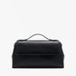 The Proenza Schouler Tate Clutch is a compact black leather bag with a top handle, front flap, and detachable crossbody strap, shown on a plain white background.