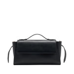 The Proenza Schouler Tate Clutch is a compact black leather bag with a top handle, front flap, side straps, and detachable crossbody strap, elegantly showcased against a white background.