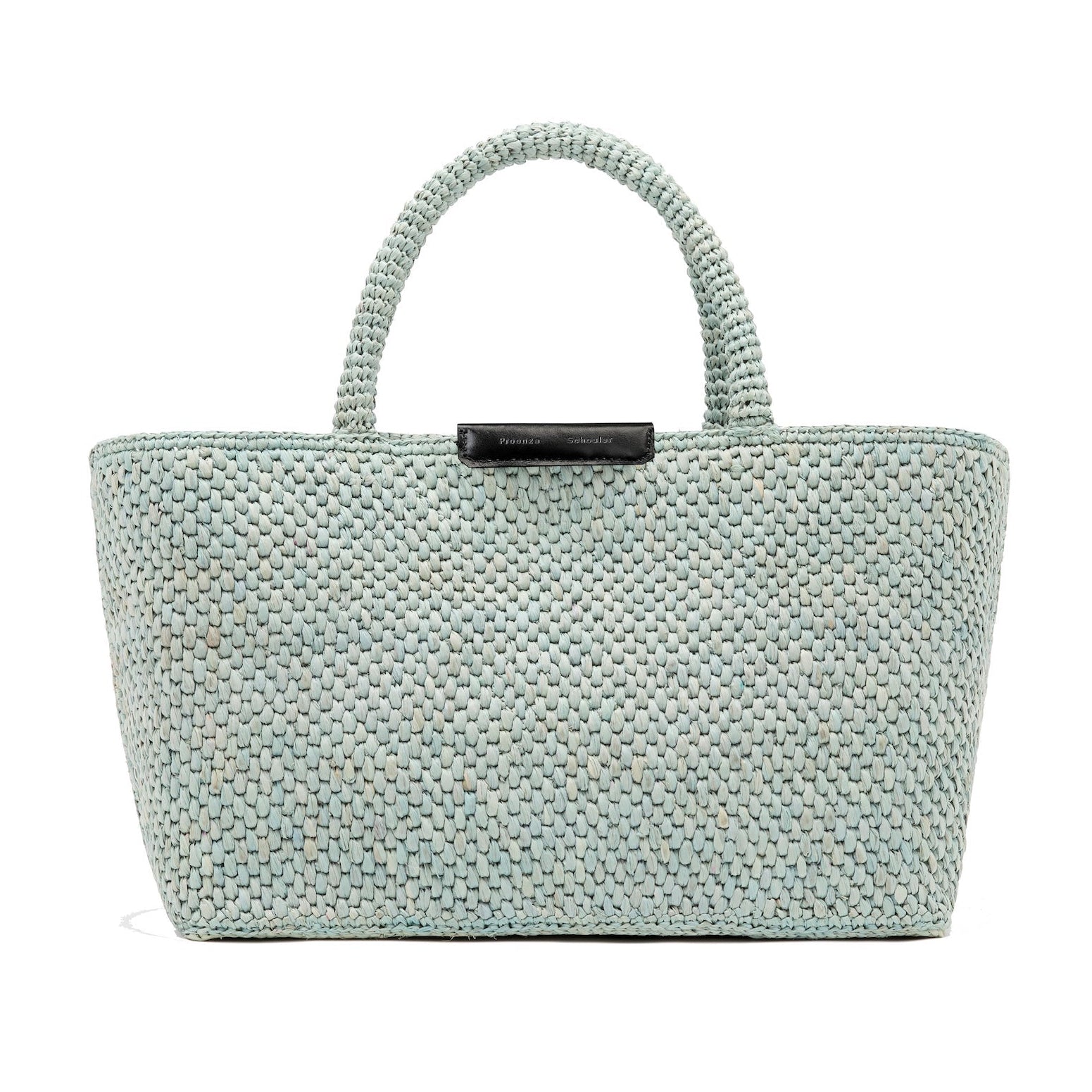 The East West Raffia Chelsea Tote by Proenza Schouler is a light blue woven bag featuring two sturdy handles and a black label at the top center, showcased against a plain white background.