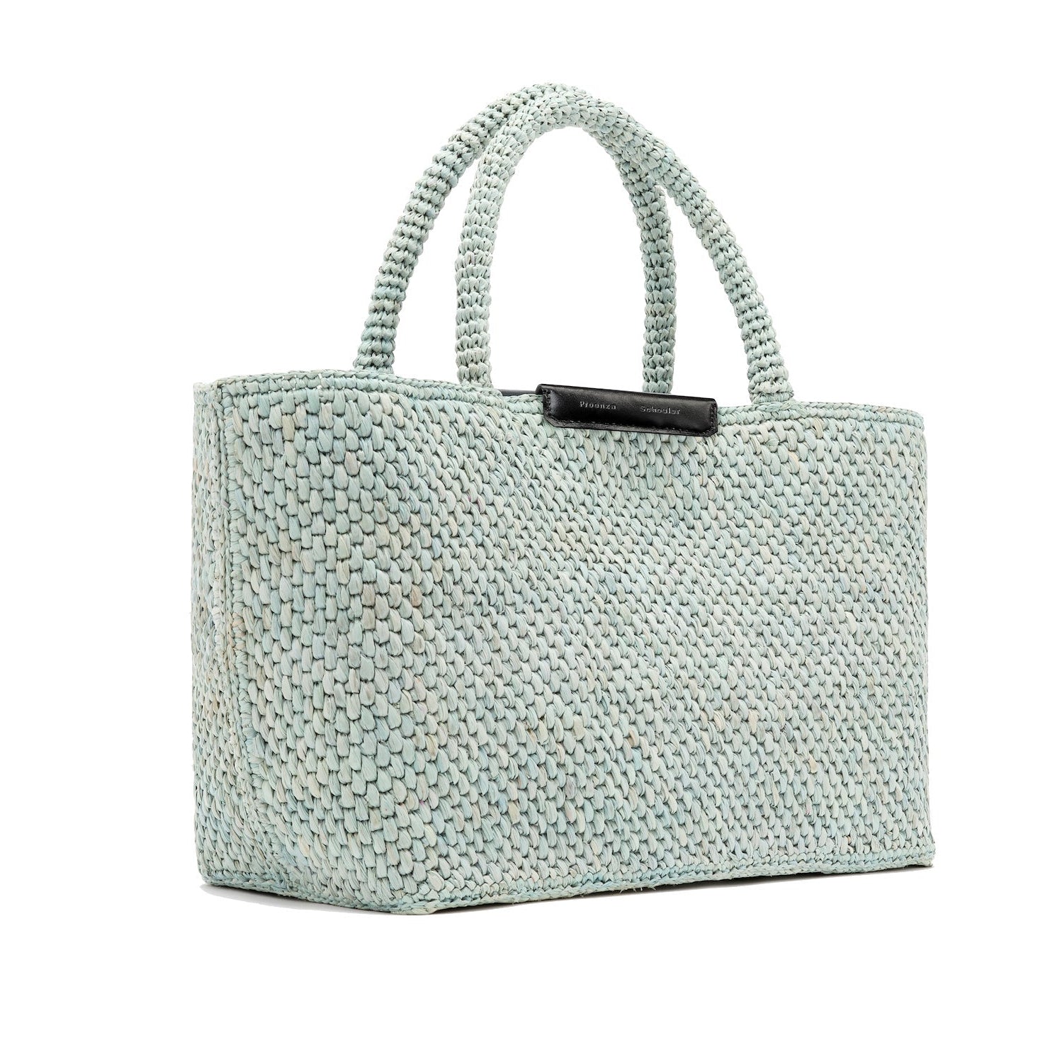 The East West Raffia Chelsea Tote by Proenza Schouler is a structured rectangular handbag in woven light blue, featuring two short handles and displayed at an angle against a white background.