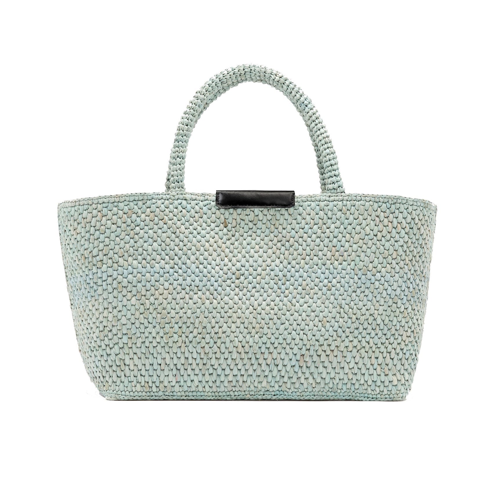 The Proenza Schouler East West Raffia Chelsea Tote is a light blue woven handbag featuring two handles and a small black rectangular accent near the top center. This structured tote is displayed against a plain white background.