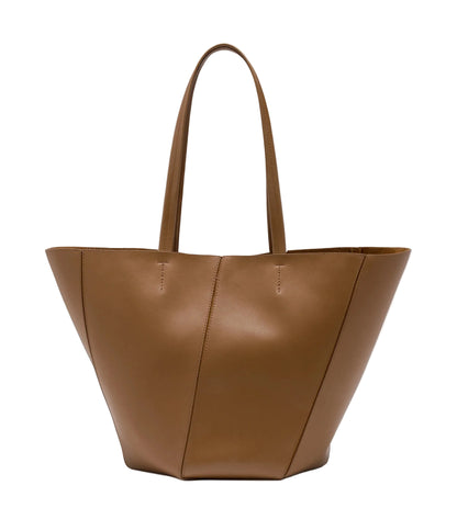 The Proenza Schouler Hex Tote is a large brown calf leather bag featuring two handles, subtle stitching, and a clean, minimalist design.