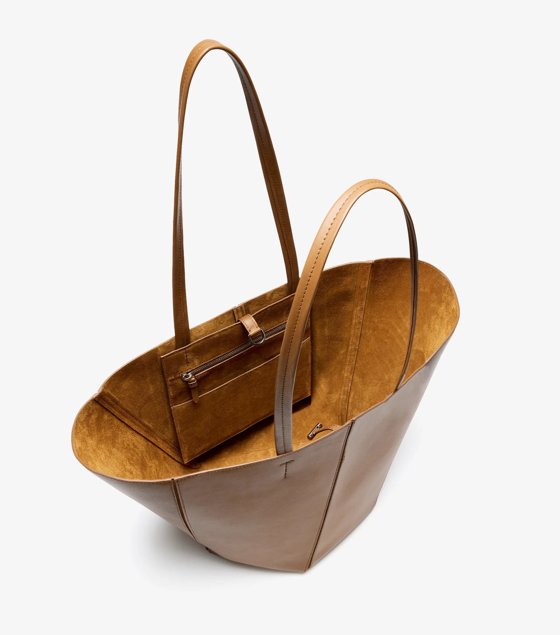 The Hex Tote by Proenza Schouler is a brown calf leather bag with long handles and includes a smaller zippered pouch, displayed against a plain white background.