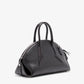 The Proenza Schouler Small Bowler Bag, crafted in black leather with two handles, a distinctive triangular shape, visible zipper closure, and silver-tone hardware, is displayed against a plain white background.