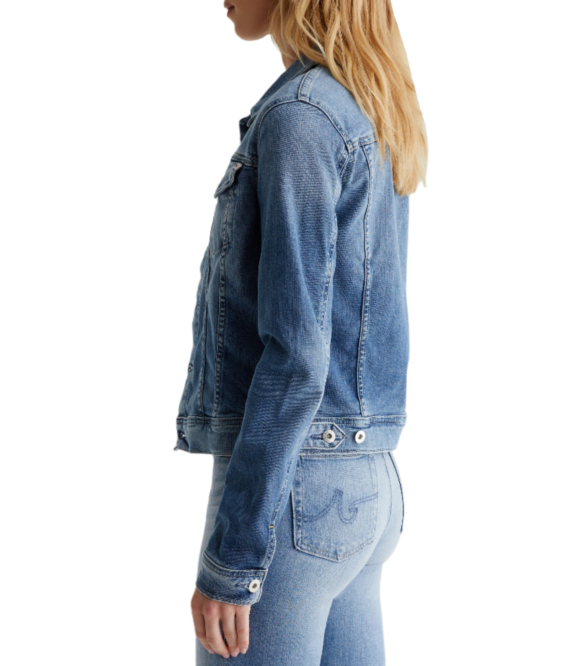 Side profile of a person wearing an AG Jeans AG Robyn Denim Jacket and matching jeans.