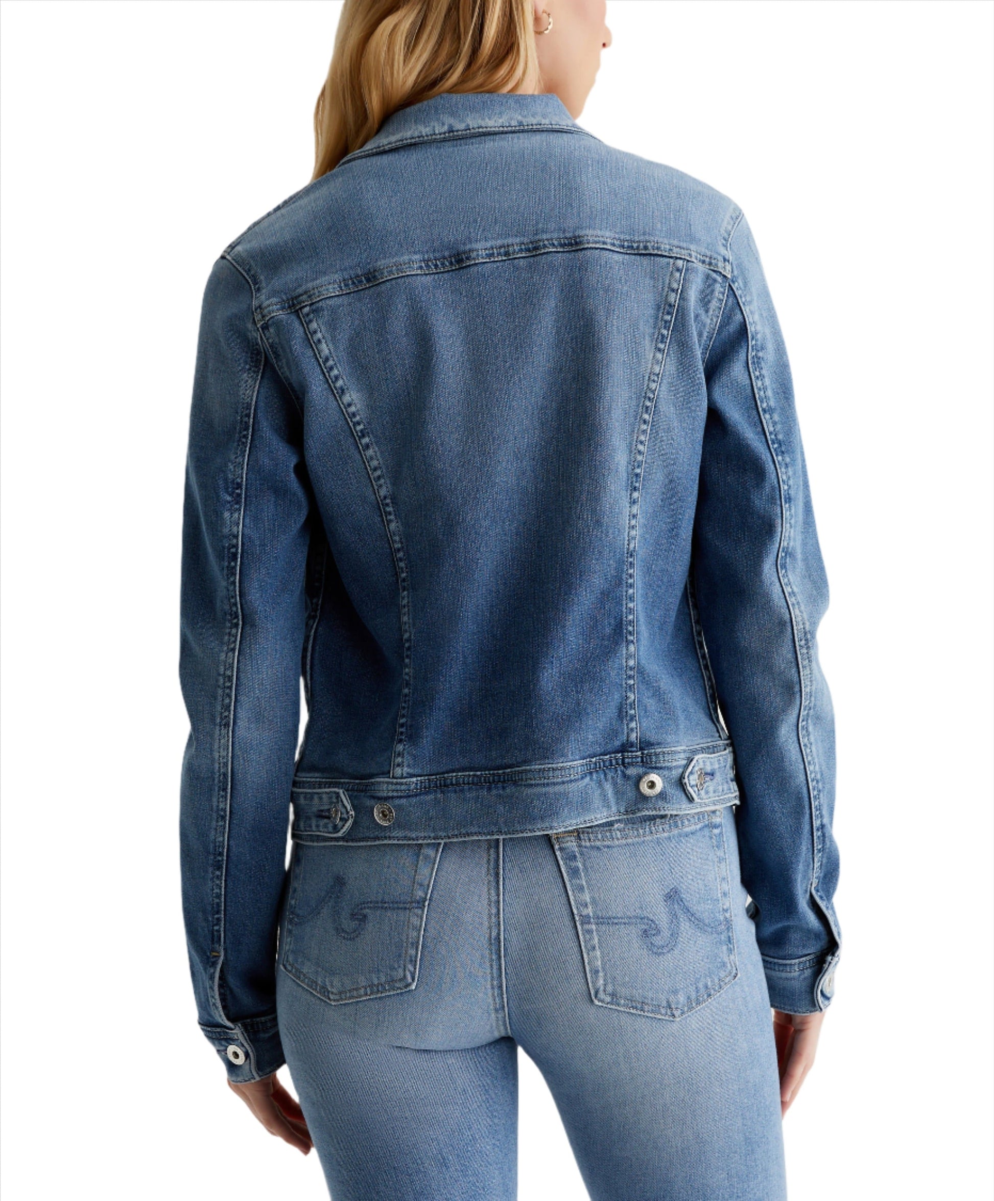 Back view of a person wearing an AG Robyn Denim Jacket made from AG Cloud Soft Denim™ and light wash jeans.