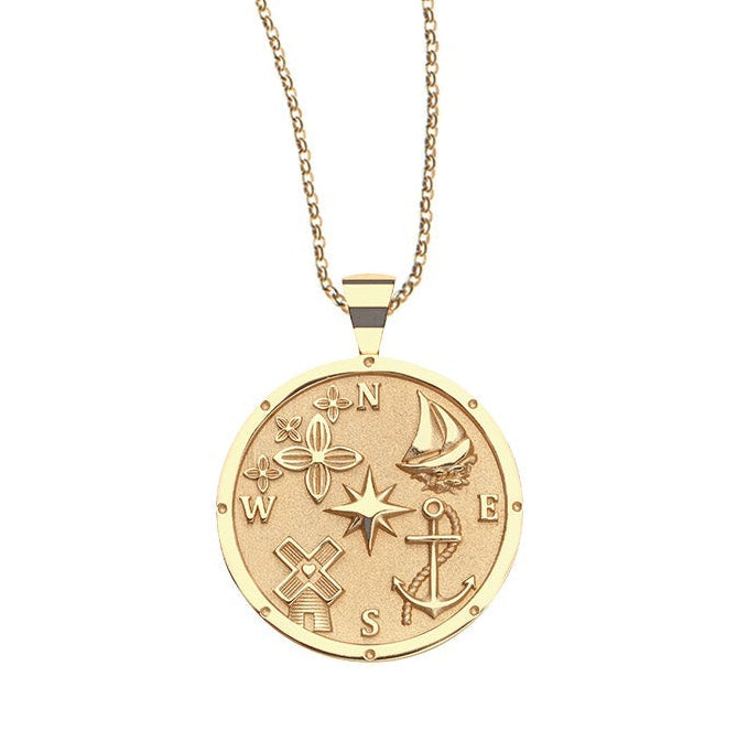 The Destination Pendant Necklace Collection by Jane Win features a gold coin pendant engraved with symbols like the sun, star, airplane, sailboat, anchor, and compass—a standout piece for any necklace collection.
