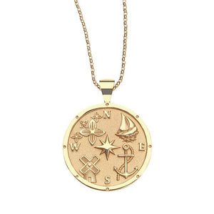 The Destination Pendant Necklace Collection by Jane Win features a gold coin pendant engraved with symbols like the sun, star, airplane, sailboat, anchor, and compass—a standout piece for any necklace collection.