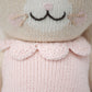 Close-up of Hannah the Bunny, Blush - Regular 20" by Cuddle + Kind, wearing a light pink knitted top with a scalloped collar. Features stitched details and rosy cheeks—an inspiring gift or sweet birthday toy.