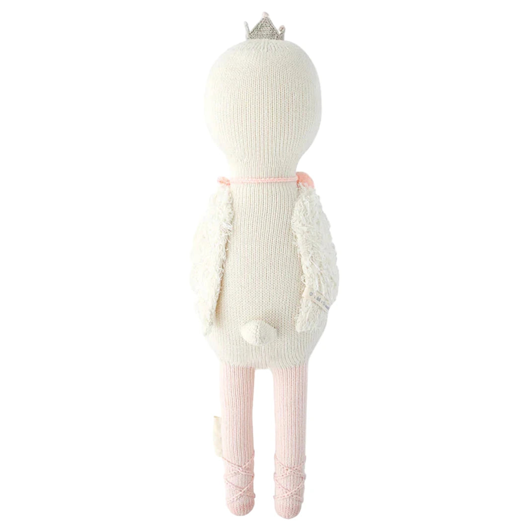 Harlow the Swan - Regular 20" by Cuddle + Kind is a knitted plush doll with a small crown, lace wings, and pink legs, seen from the back—ready to soar or dance with brave wings.