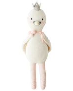 Harlow the Swan - Little 13" by Cuddle + Kind is a knitted white bird doll with brave wings, a silver crown, pink blush, a pink tie at the neck, and pink ballet shoes—ready for dancing adventures.