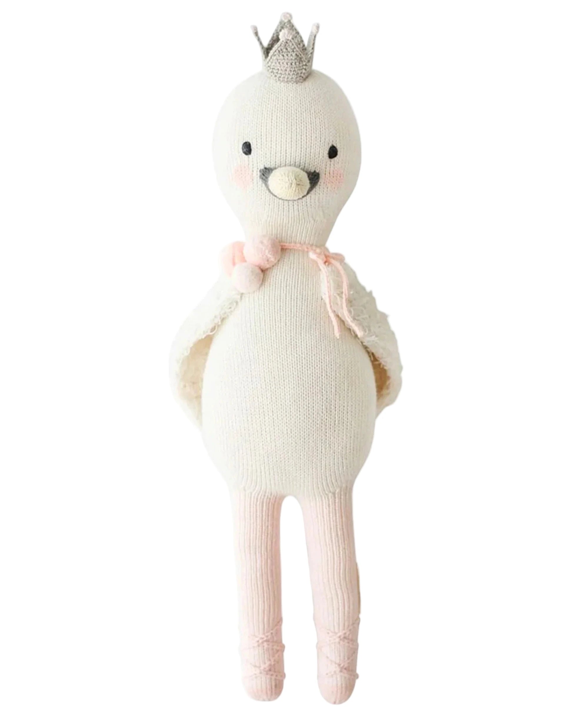 Harlow the Swan - Little 13" by Cuddle + Kind is a knitted white bird doll with brave wings, a silver crown, pink blush, a pink tie at the neck, and pink ballet shoes—ready for dancing adventures.