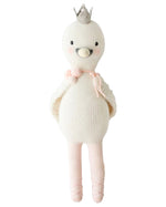 Harlow the Swan by Cuddle + Kind is a 20" knitted doll with a silver crown, pink blush, a pink tie, and ballet shoes—ready to dance with brave wings.