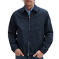 A man in a Rag & Bone Harrington Cotton Jacket, navy blue, over a blue plaid shirt, stands with hands in pockets against a white background.