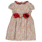 The Kidiwi Hars Smocked Dress by Kidiwi is a 100% cotton toddler dress adorned with a floral pattern, short sleeves, and an iconic red bow at the waist.